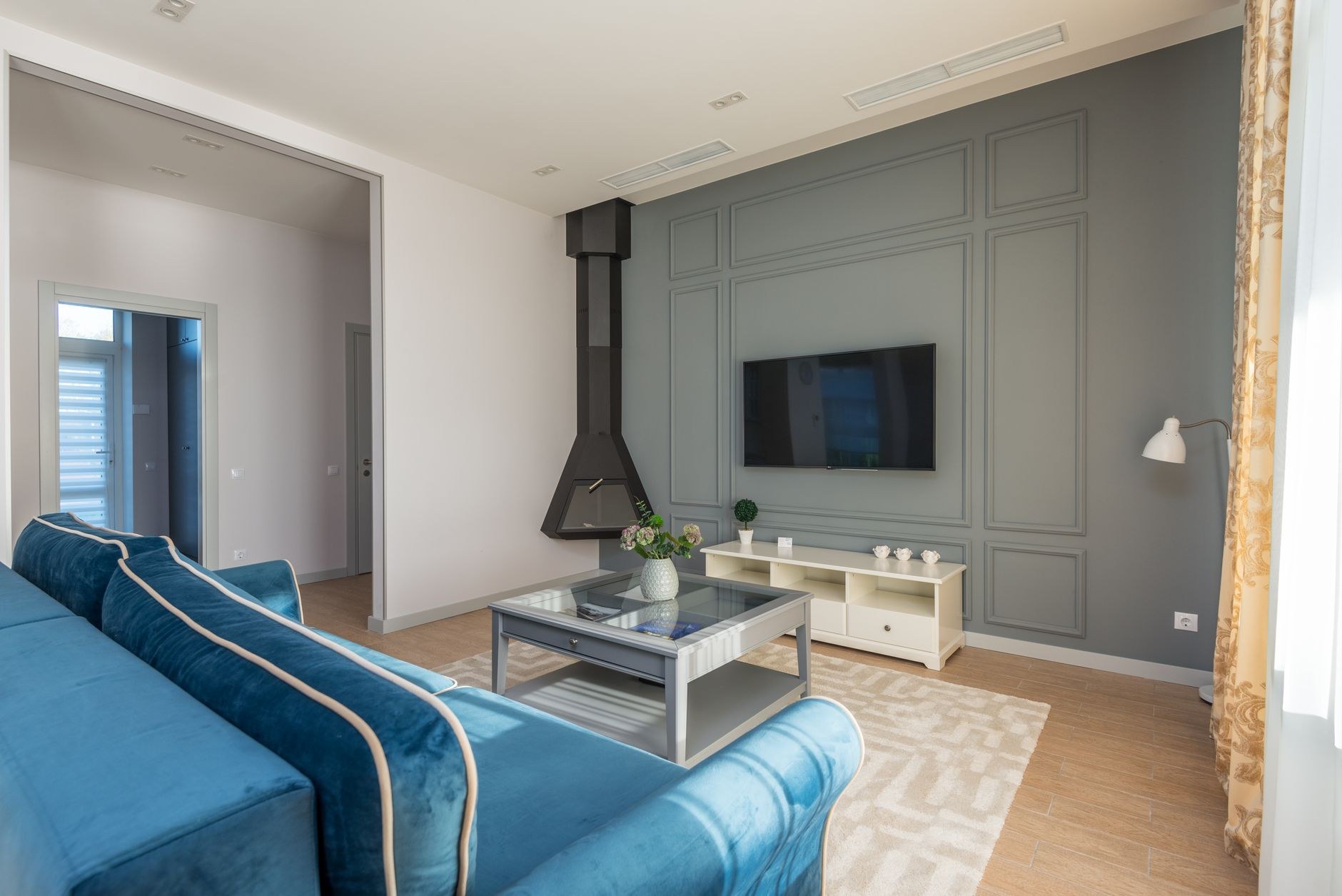 A living room warmed by a wall-mounted heat pump